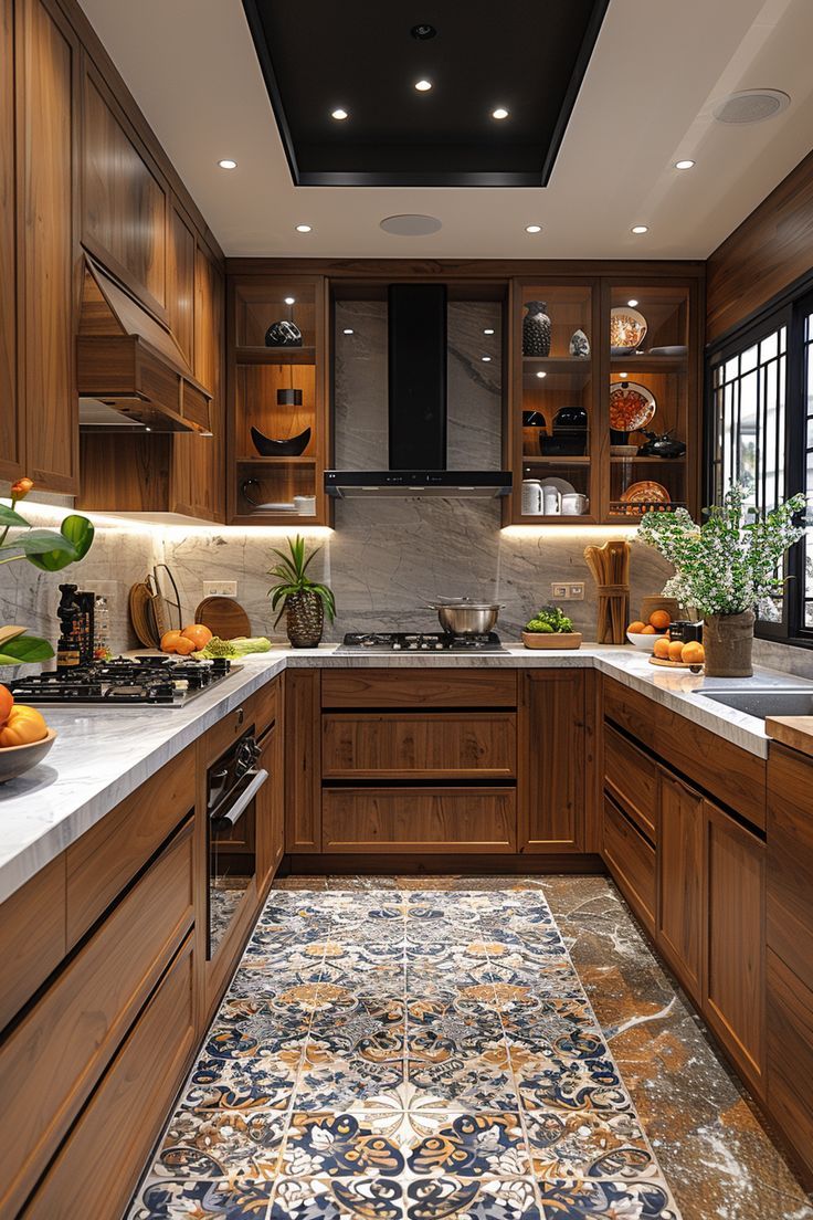 Walnut U-shaped kitchen with two hobs, marble splashback and lit display cabinets