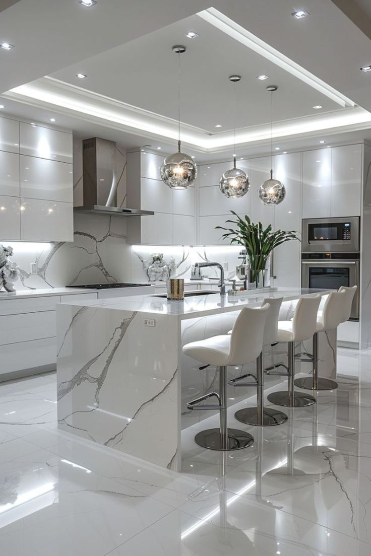 White kitchen with marble waterfall island, bar stools and built-in oven tower